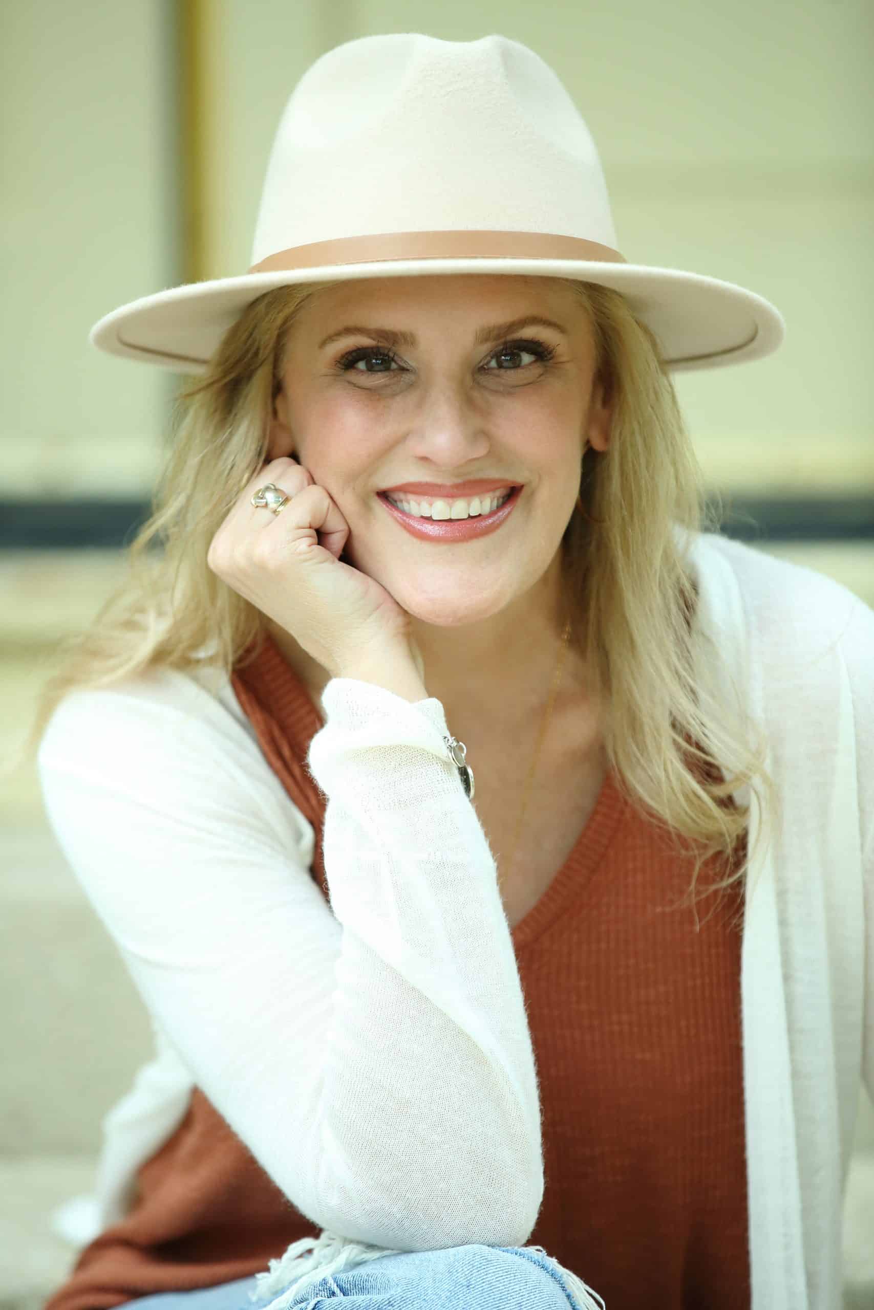 A blonde woman wearing a hat and jeans. A blonde woman wearing a hat and jeans.