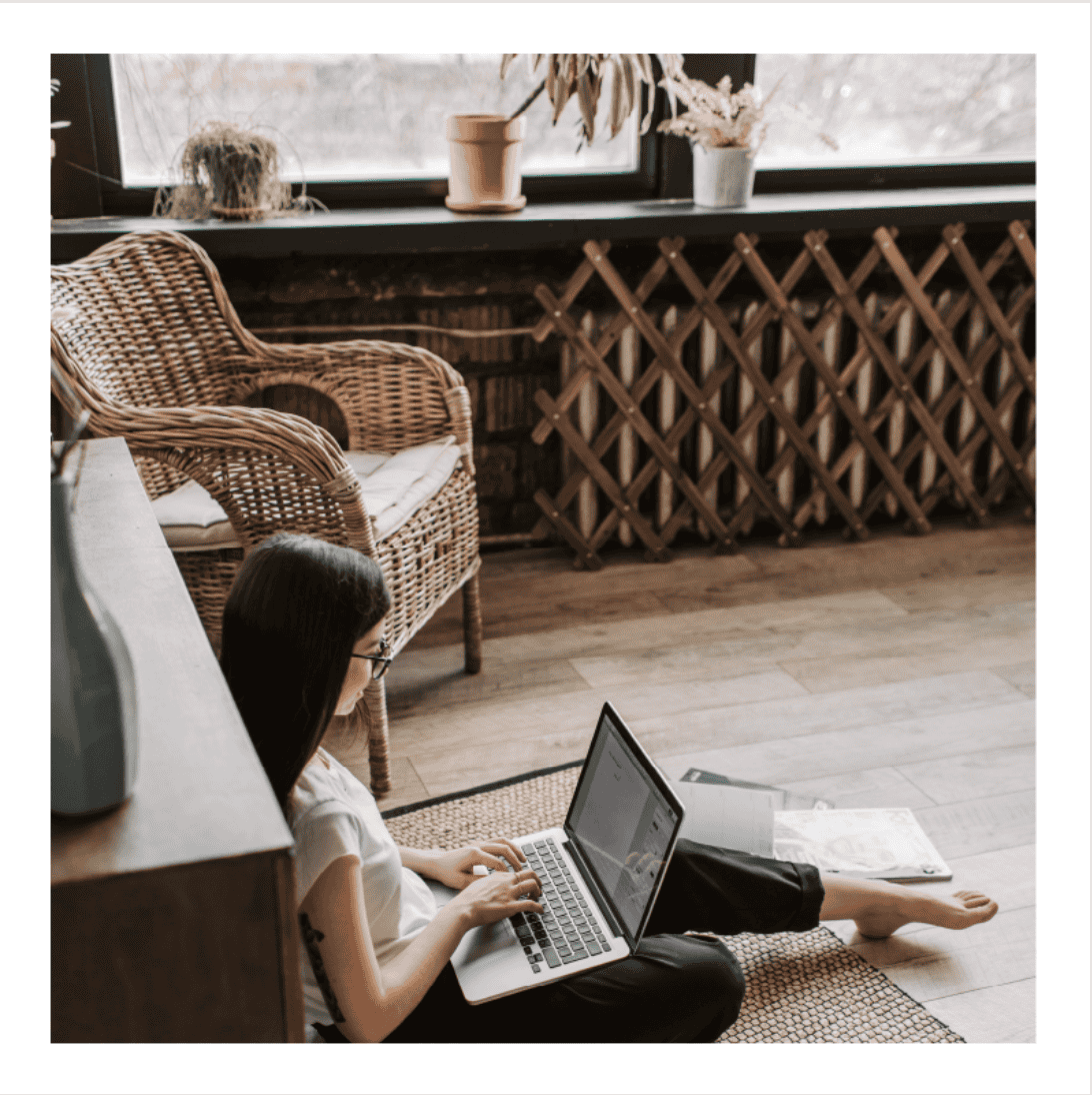 Woman donating at her computer Woman sitting on her floor with a laptop, donating to Jill Monaco Ministries