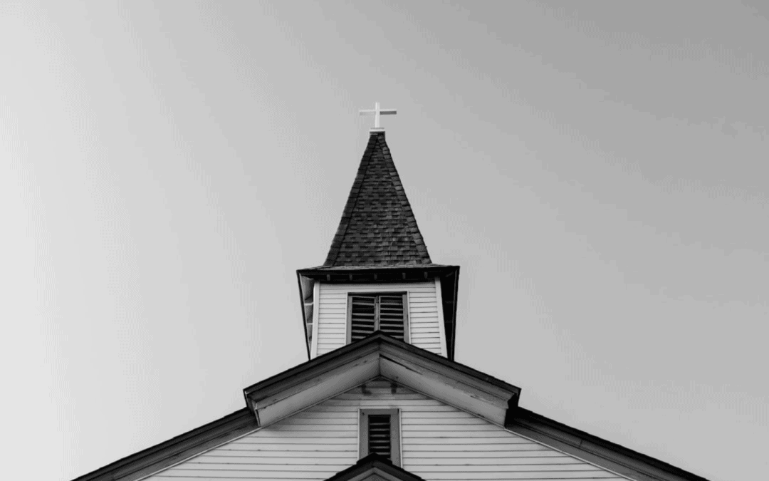 photo of church steeple with cross in black and white photo